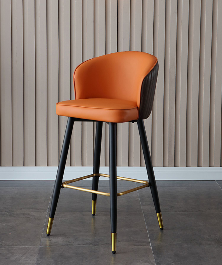 Front view of a single orange leather bar stool with black metal legs, golden footrest, and modern design, ideal for stylish interiors.