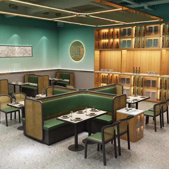 Restaurant booths with green cushioned seating, marble tables, and modern ambiance, featuring a stylish design with cane material backs.