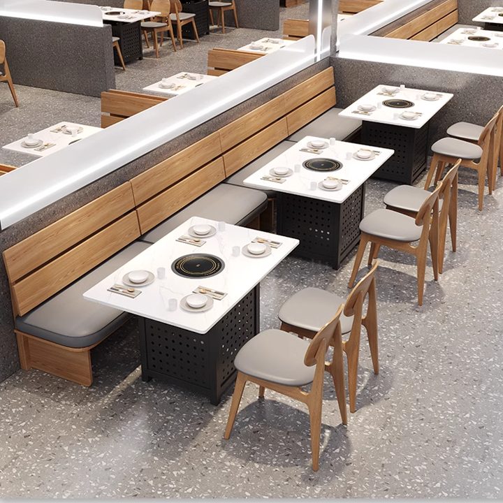  restaurant seating arrangement with marble tables and wooden chairs with grey cushions