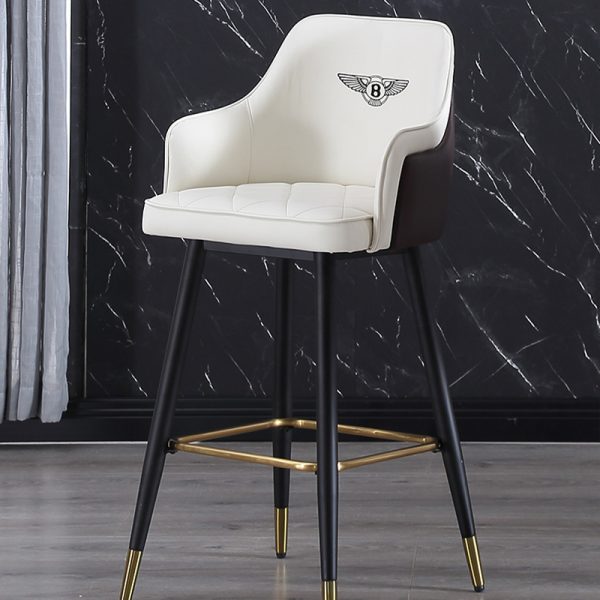 White leather barstool with brown backrest, gold metal base, and modern design featuring sleek lines.