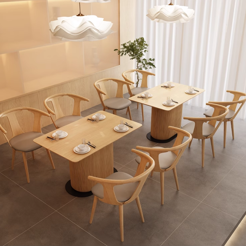 A modern wooden dining set with fluted legs and round chairs, featuring a minimalist design ideal for contemporary spaces.