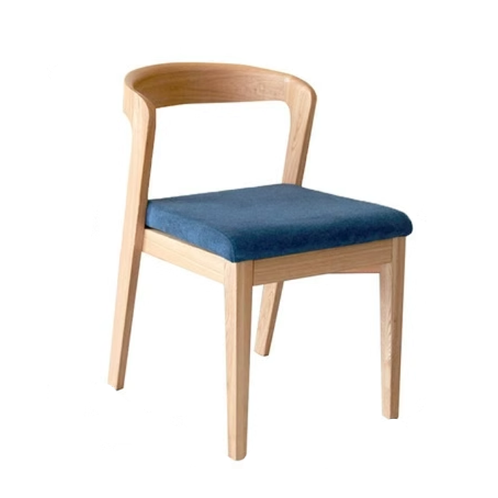 Wooden dining chair with blue cushion, minimalist design, modern furniture.