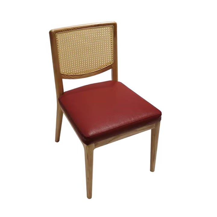 Wooden cane chair with red leather seat, elegant design, for dining room, ergonomic and stylish.